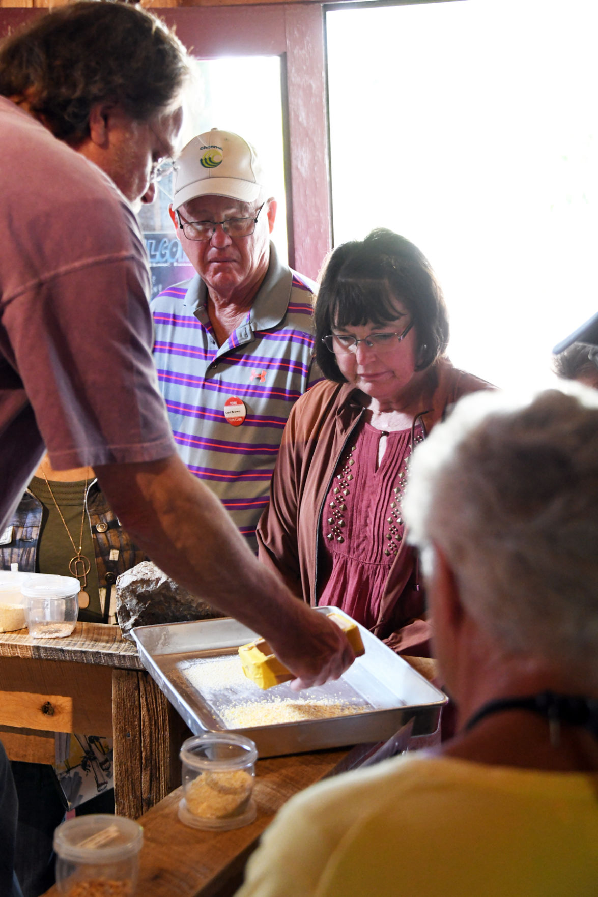 014 Carl Brown and Mary Folkerts viewed the textures of corn that could be ground at the gristmill.jpg